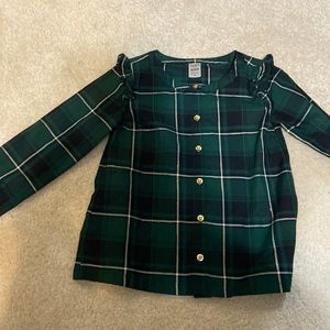 This is a little girls green plaid shirt.
